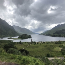 NHSCOT Trip to Scotland a view of a scottish country side, tower and ocean